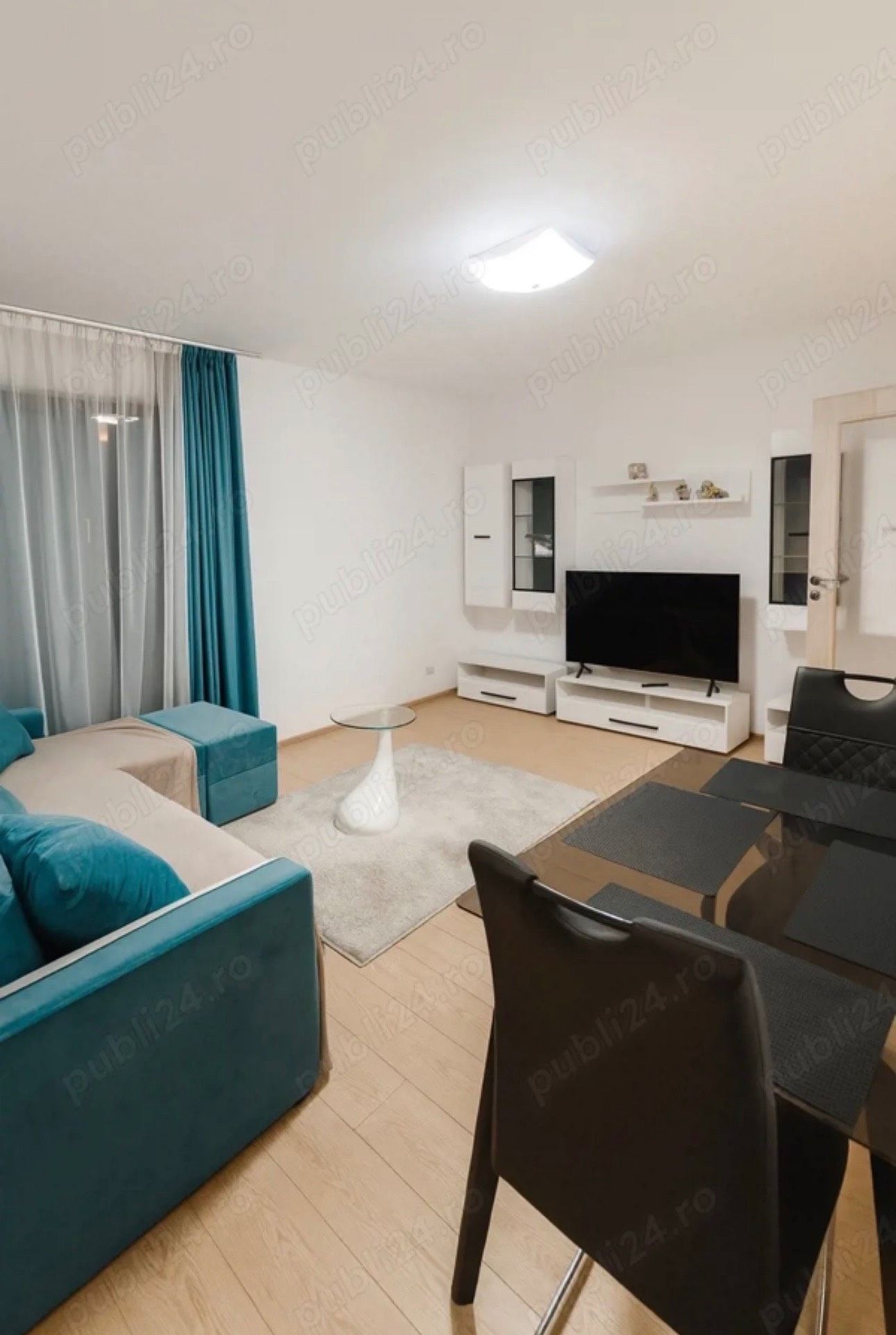 A living room with sofa, chair and TV