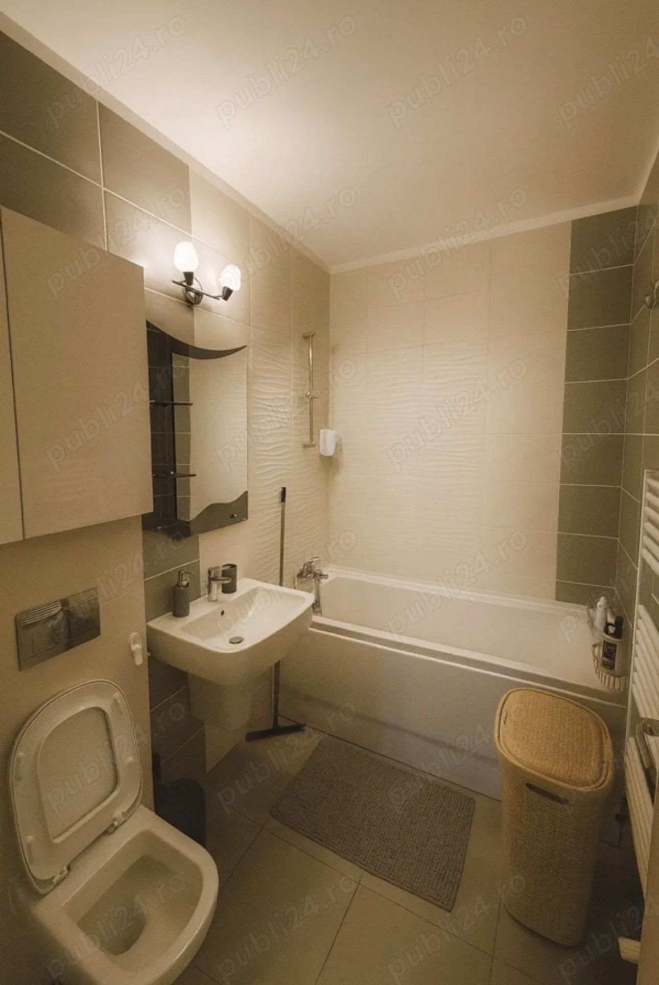 A bathroom with laundry, mirror and bathroom