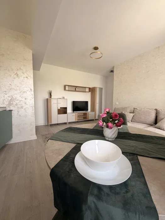 A living room with a white bowl on a table