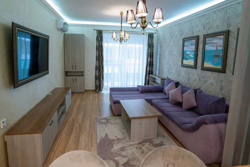 The space is shared between four rooms, with the main furniture located in the center of the common hall