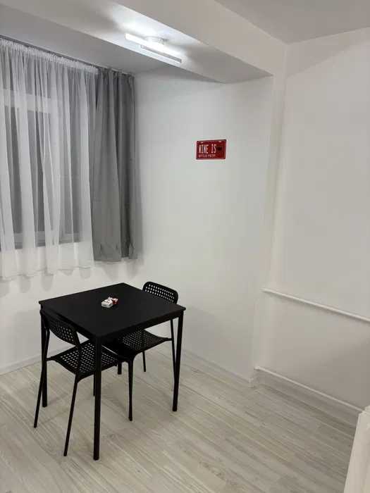 A small room with a table and chairs