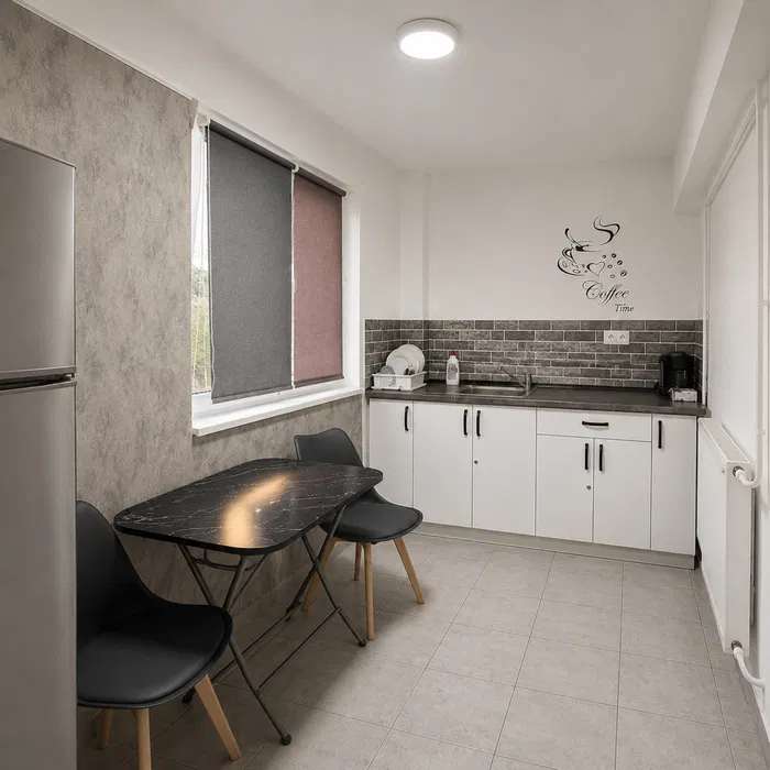A small, clean and well-lit room with a table and chairs