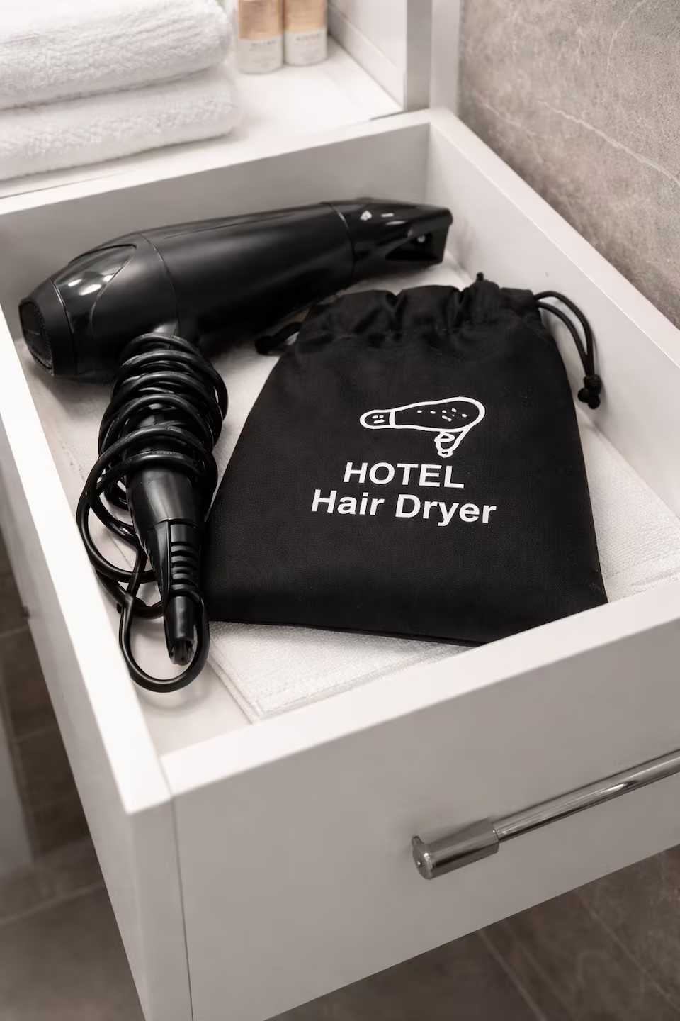 A hotel room with a hair dryer and a black bag — studio in Oradea