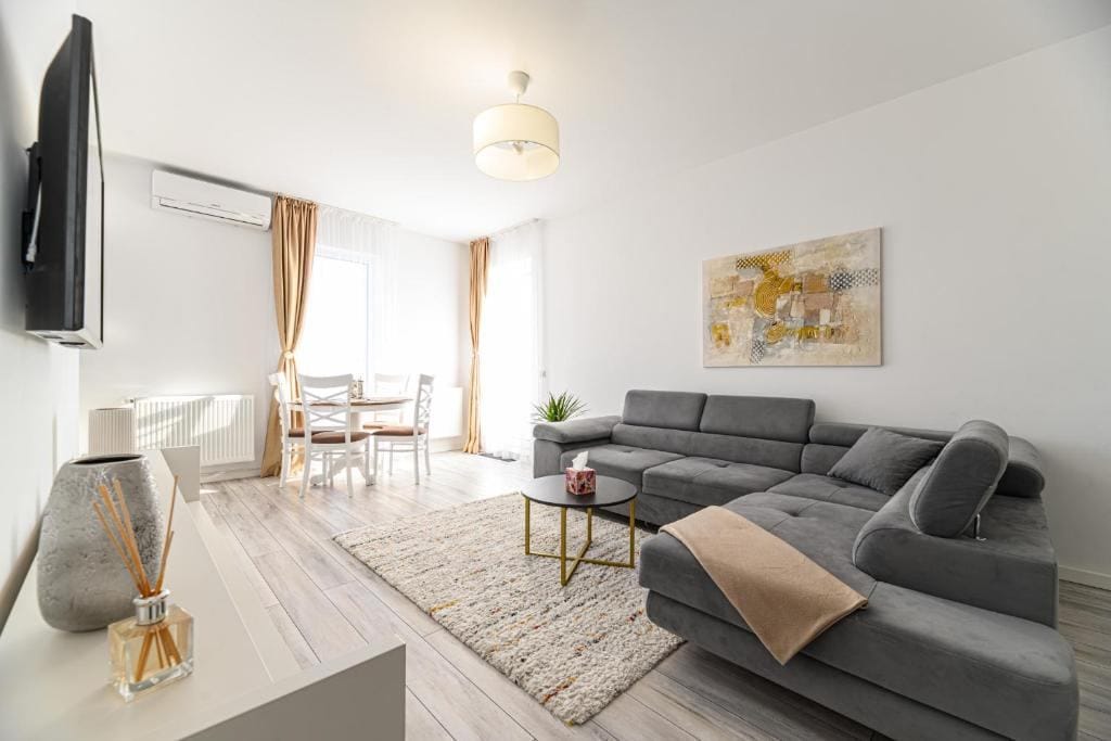 A living room with sofa, table and chair — apartment in Brașov