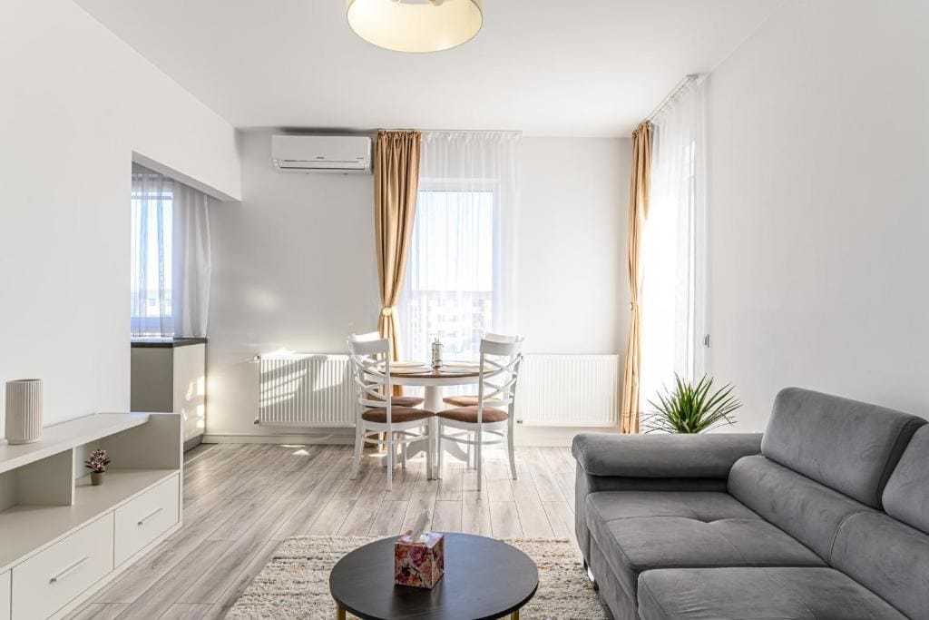 A living room with sofa, table and window — apartment in Brașov