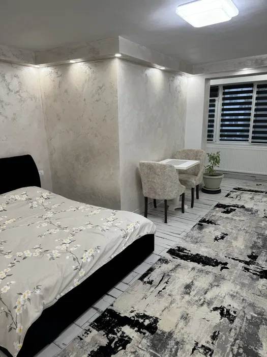 A room with a bed, a chair and a window