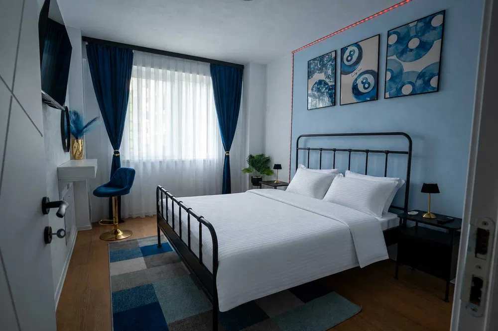 A room with a bed, a chair and a window