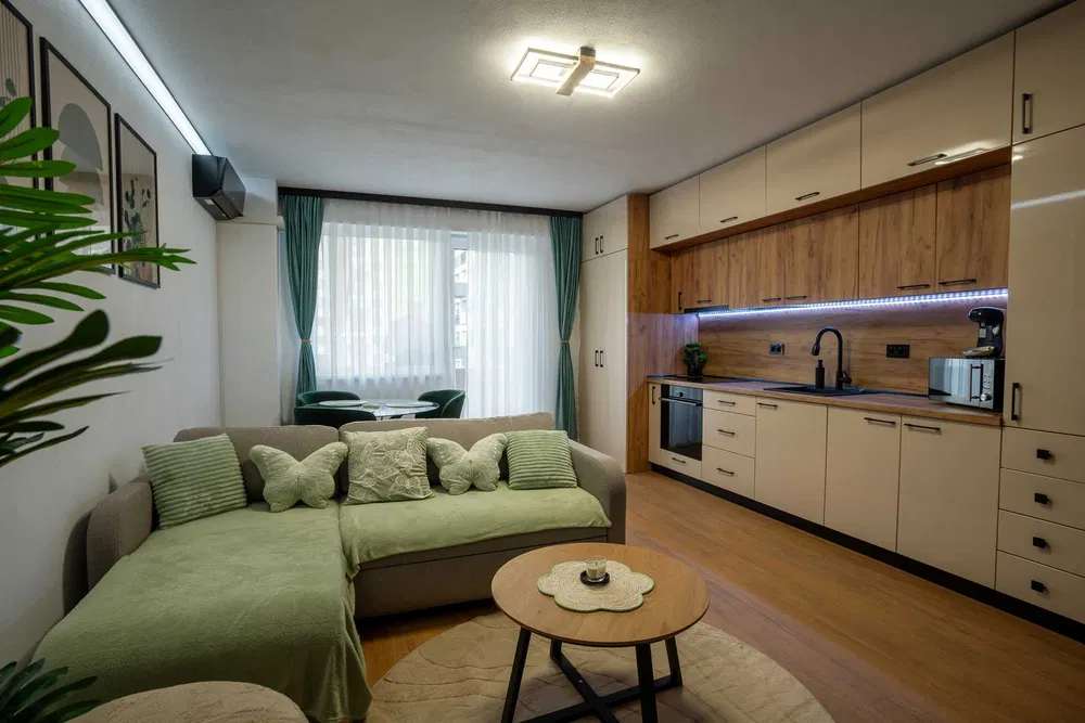 A living room with sofa, table and window