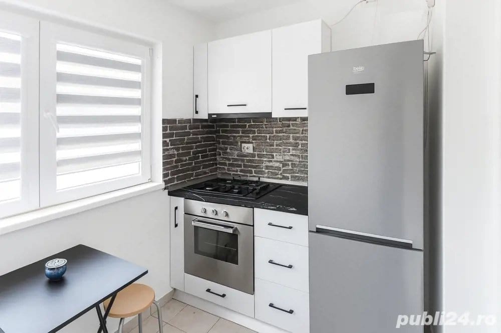 A small kitchen with a white refrigerator and oven