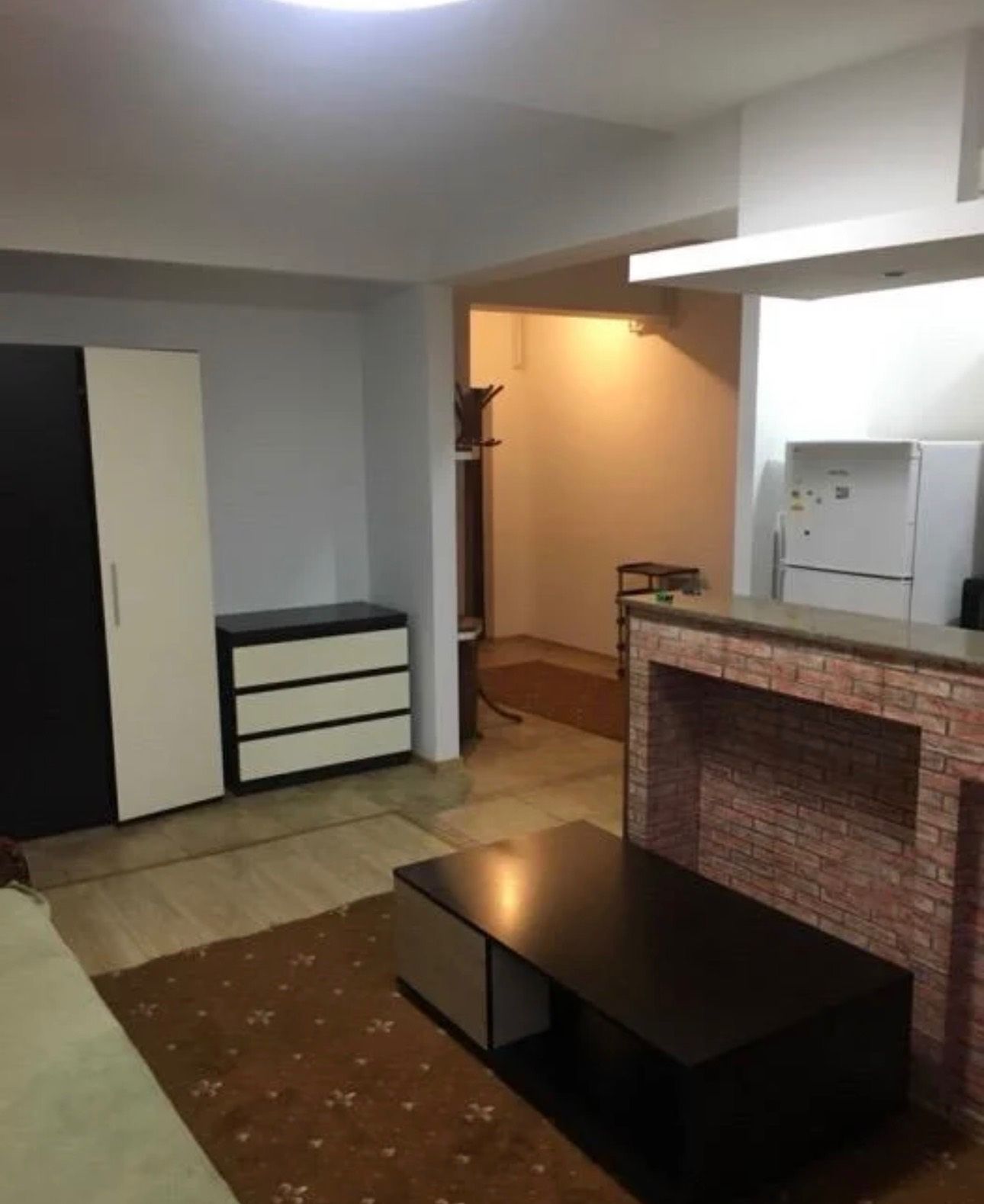 A living room with a fireplace and a table