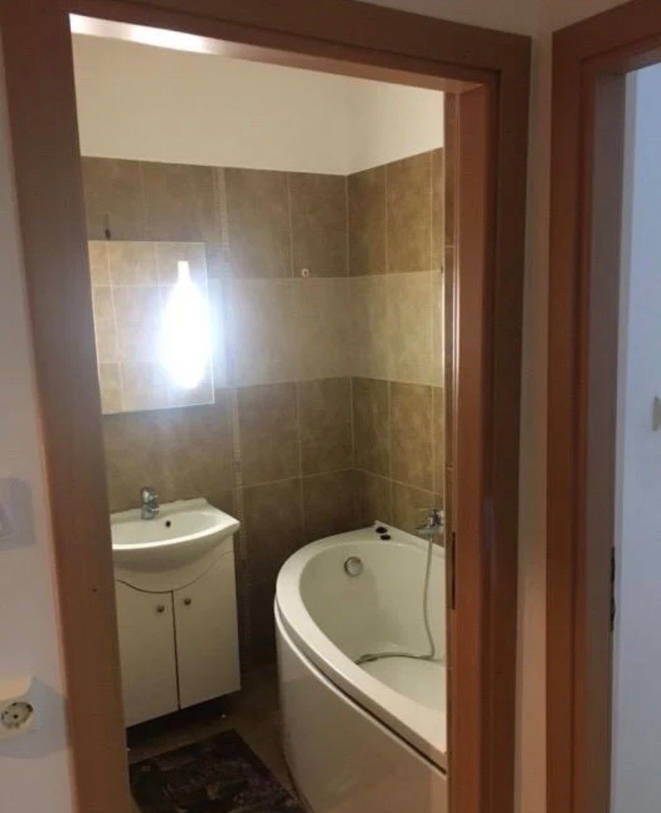 A bathroom with a white bathroom and a white couch