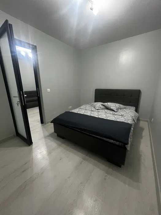 A room with a bed and a door.