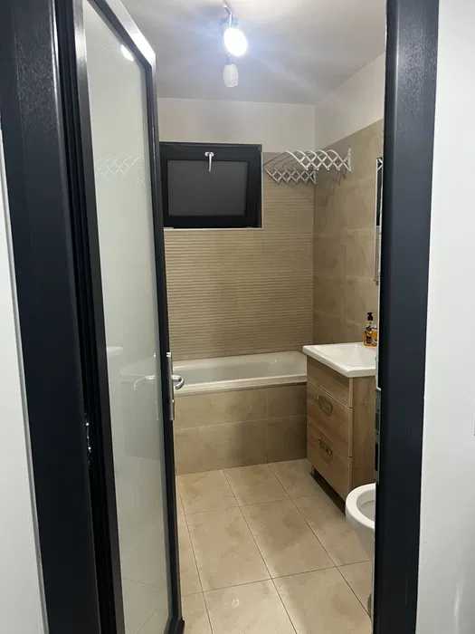 A bathroom with toilet and TV