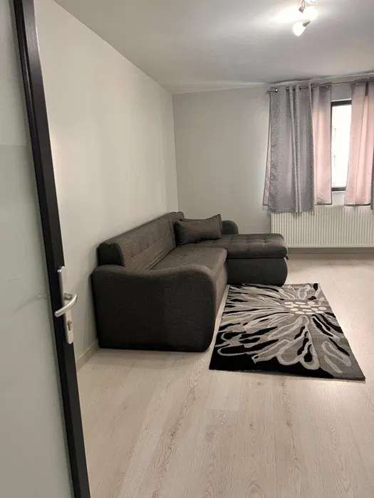 A small room with sofa and carpet