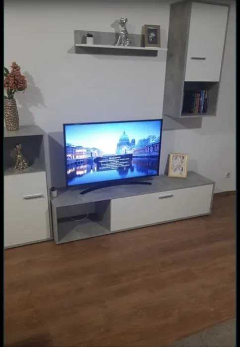 A room with a flat screen TV and a window