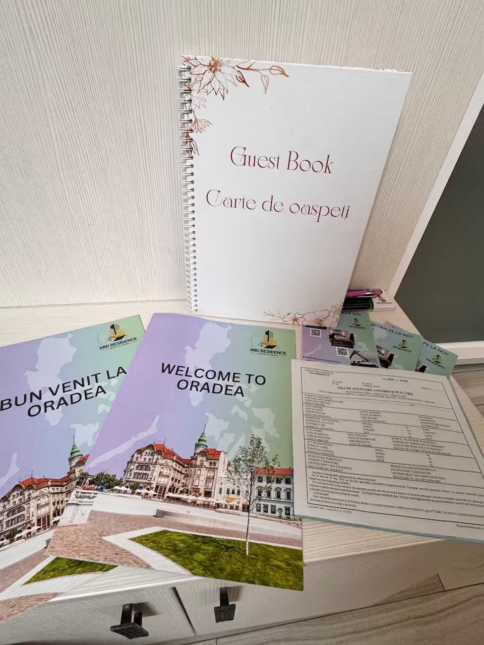 A guest book and a booklet for a hotel — apartment in Oradea