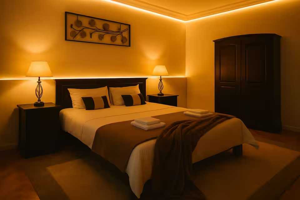 A room with a bed and a lamp — apartment in Oradea