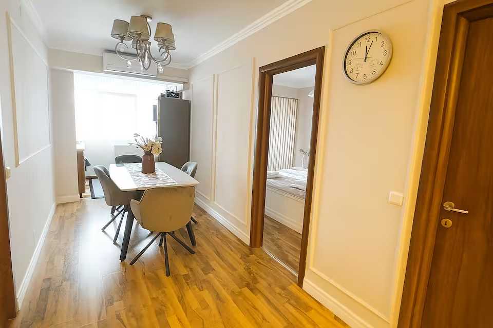 A small, clean and well-lit room with a table and chairs — apartment in Oradea