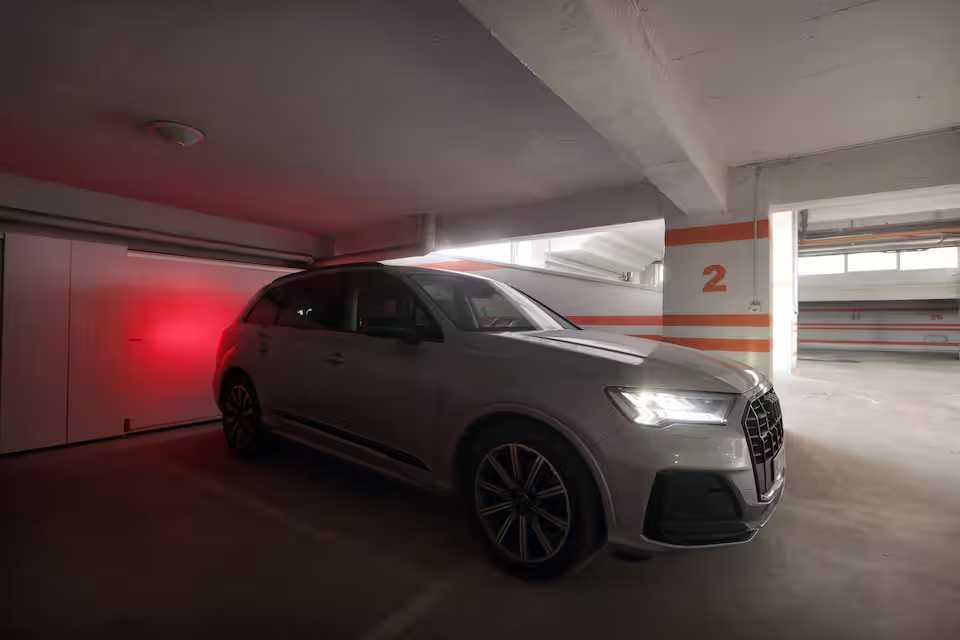 A white car is parked in a garage — apartment in Oradea