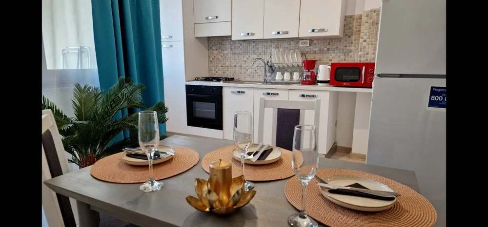 A kitchen with microwave, oven and cabinets